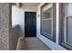 Front entryway featuring a secure black front door and exterior window detail at 45 Maleena Mesa St # 1424, Henderson, NV 89074