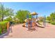 Community playground featuring slides, climbing apparatus, and benches surrounded by mature trees at 45 Maleena Mesa St # 1424, Henderson, NV 89074