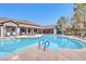 Resort-style pool and spa surrounded by lounge chairs and mature landscaping at 45 Maleena Mesa St # 1424, Henderson, NV 89074