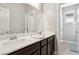 Bathroom featuring double sinks, dark wood cabinets, and tiled floors at 4630 Adonis Blue St, North Las Vegas, NV 89031