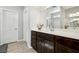 Bathroom featuring a single sink, dark wood cabinets, and tiled floors at 4630 Adonis Blue St, North Las Vegas, NV 89031