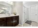 Bathroom featuring a single sink, dark wood cabinets, and tiled floors at 4630 Adonis Blue St, North Las Vegas, NV 89031
