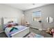 This bedroom offers a window, door, and plush carpet at 4630 Adonis Blue St, North Las Vegas, NV 89031