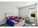 A bedroom with a racecar bed, window and fun decorations for a playful space at 4630 Adonis Blue St, North Las Vegas, NV 89031