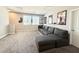 Spacious bonus room featuring a large sectional sofa, natural light, and ample space for activities at 4630 Adonis Blue St, North Las Vegas, NV 89031