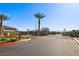 Gated entrance to the community with well-maintained landscaping and palm trees at 4630 Adonis Blue St, North Las Vegas, NV 89031