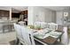 Inviting dining area with a large table set for a meal, complemented by neutral decor and ample natural light at 4630 Adonis Blue St, North Las Vegas, NV 89031