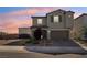 Charming two-story home with a well-maintained lawn, brick-paved driveway, and a warm-toned sunset in the background at 4630 Adonis Blue St, North Las Vegas, NV 89031