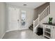Bright foyer featuring tiled floors, white door, and staircase leading to the upper level at 4630 Adonis Blue St, North Las Vegas, NV 89031