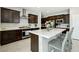 This spacious kitchen features dark wood cabinetry, white countertops, and a stainless steel oven and range hood at 4630 Adonis Blue St, North Las Vegas, NV 89031
