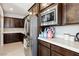 This is a close-up of a kitchen counter with stainless steel appliances and dark wood cabinets at 4630 Adonis Blue St, North Las Vegas, NV 89031