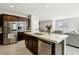 Modern kitchen with stainless steel appliances, a kitchen island, and dark wood cabinets that add a touch of elegance at 4630 Adonis Blue St, North Las Vegas, NV 89031