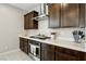 Modern kitchen features stainless steel range hood, quartz countertops, and dark wood cabinets at 4630 Adonis Blue St, North Las Vegas, NV 89031