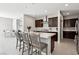Modern kitchen features an island with seating, stainless steel appliances, and stylish finishes at 4630 Adonis Blue St, North Las Vegas, NV 89031