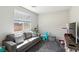 Comfortable living room with neutral colors, natural light, and view to backyard at 4630 Adonis Blue St, North Las Vegas, NV 89031