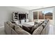 Open living room with media center and large sectional sofa next to a sliding glass door at 4630 Adonis Blue St, North Las Vegas, NV 89031