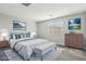 Serene main bedroom with king-sized bed, elegant decor, and ample natural light at 4630 Adonis Blue St, North Las Vegas, NV 89031
