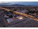 An aerial view captures the home, storage building, and a lit outdoor basketball court on a spacious lot at 5315 N Fort Apache Rd, Las Vegas, NV 89149