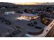 Aerial view of a well-lit outdoor basketball court behind a residence, featuring a sizable storage facility at 5315 N Fort Apache Rd, Las Vegas, NV 89149