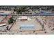 Aerial shot shows a vast lot with a single story home, detached outbuilding, and views of the surrounding community at 5315 N Fort Apache Rd, Las Vegas, NV 89149