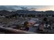 Aerial shot at dusk shows a large lot, single story home, and basketball court with mountain views in background at 5315 N Fort Apache Rd, Las Vegas, NV 89149