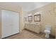 Bathroom with a double vanity, marble countertop, and white cabinets, plus a toilet and tile floor at 5315 N Fort Apache Rd, Las Vegas, NV 89149