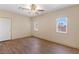 Bright bedroom featuring wood-look floors, a ceiling fan, and natural light from two windows at 5315 N Fort Apache Rd, Las Vegas, NV 89149