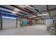 Spacious garage featuring multiple roll-up doors, shelving, and high ceilings at 5315 N Fort Apache Rd, Las Vegas, NV 89149
