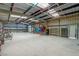 Large garage with roll-up doors, shelving and high ceilings, ideal for storage or workshop at 5315 N Fort Apache Rd, Las Vegas, NV 89149