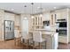 Bright kitchen features stainless appliances, a granite island with bar seating, and custom cabinetry at 5315 N Fort Apache Rd, Las Vegas, NV 89149