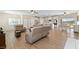 Open-concept living area and kitchen featuring lots of natural light, wood laminate flooring, and neutral paint at 5315 N Fort Apache Rd, Las Vegas, NV 89149