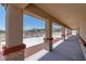 Covered patio featuring stone support columns and a view of the expansive backyard at 5315 N Fort Apache Rd, Las Vegas, NV 89149