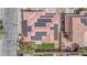 Birds eye view of a red tiled roof and solar panels with lush green grass in the backyard at 5345 Tustin Hills St, North Las Vegas, NV 89081