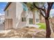 Backyard featuring artificial lawn, a patio, and mature landscaping at 5345 Tustin Hills St, North Las Vegas, NV 89081
