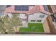 This backyard has green grass, desert landscaping and solar panels on the roof at 5345 Tustin Hills St, North Las Vegas, NV 89081