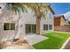 Spacious backyard with artificial lawn, a patio, and mature landscaping at 5345 Tustin Hills St, North Las Vegas, NV 89081