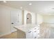 Bright basement featuring an island, stainless steel appliances, white cabinets and quartz countertops at 5345 Tustin Hills St, North Las Vegas, NV 89081