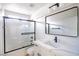 Bathroom featuring modern vanity, sleek black fixtures, and tiled shower with glass door at 5345 Tustin Hills St, North Las Vegas, NV 89081