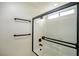 Modern bathroom shower stall with black trim and a glass door at 5345 Tustin Hills St, North Las Vegas, NV 89081