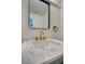 Bathroom vanity features modern hardware, quartz countertop, and a sleek gold faucet at 5345 Tustin Hills St, North Las Vegas, NV 89081