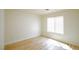 Bedroom features modern wood-look flooring and a window with bright, natural light at 5345 Tustin Hills St, North Las Vegas, NV 89081
