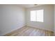 Bedroom features modern wood-look flooring and a window with bright, natural light at 5345 Tustin Hills St, North Las Vegas, NV 89081