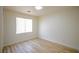 Bedroom features modern wood-look flooring and a window with bright, natural light at 5345 Tustin Hills St, North Las Vegas, NV 89081