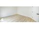 Empty bedroom with wood-look flooring and a white door at 5345 Tustin Hills St, North Las Vegas, NV 89081