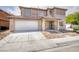 Charming two-story home with a well-manicured lawn, covered porch, and two car garage at 5345 Tustin Hills St, North Las Vegas, NV 89081