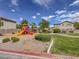 Community playground featuring slides and a play structure in a well maintained common area at 5345 Tustin Hills St, North Las Vegas, NV 89081