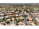 An aerial view of a neighborhood with well-maintained landscaping, pools, and tile roofs at 5436 Red Sun Dr, Las Vegas, NV 89149