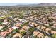 An aerial view of a well-planned community with mature trees, swimming pools, and tile roofs at 5436 Red Sun Dr, Las Vegas, NV 89149