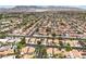 A wide aerial view of a residential area with many houses, streets, and lush trees at 5436 Red Sun Dr, Las Vegas, NV 89149