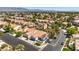 Neighborhood aerial view featuring mature trees, green lawns and red tile roofs at 5436 Red Sun Dr, Las Vegas, NV 89149